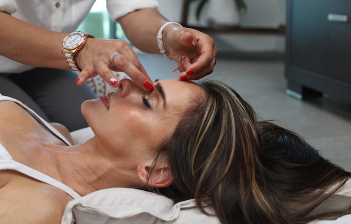 Lash artist perfecting a client's lash extensions